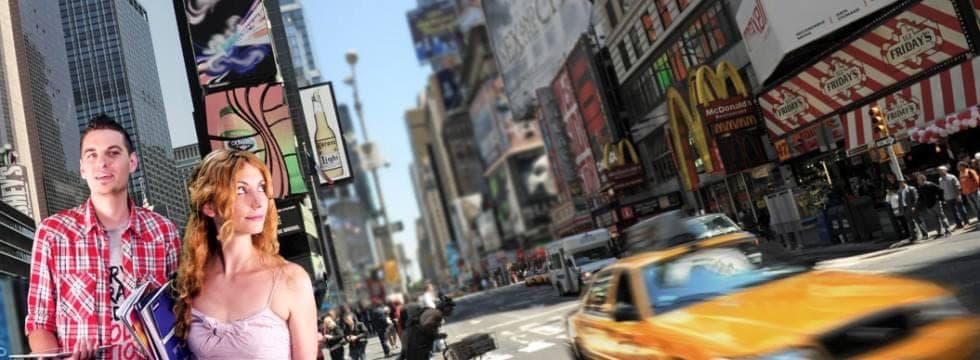 Times Square in New York: billboards, a yellow cab and people on the street.